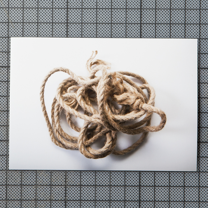 the artwork shows a pile of rope on a white background in soft light