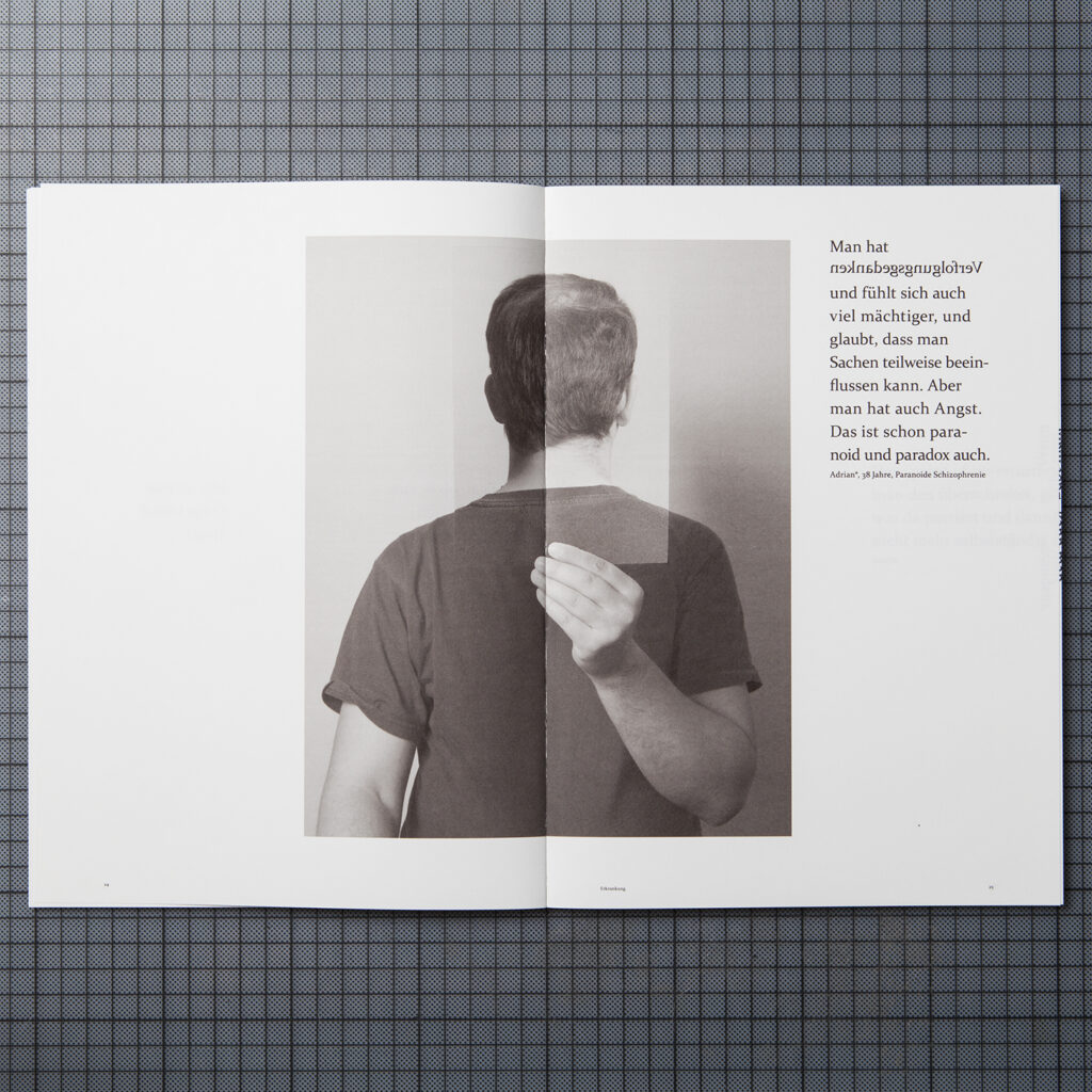 the doublepage shows a photograph of a middle aged person who is holding a photograph of the back of the head just positioned to cover his face. on the right side is a quote in which the word "persecutory thoughts" is mirrored.